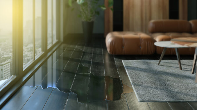 Water leaking and flooded on wood parquet floor.